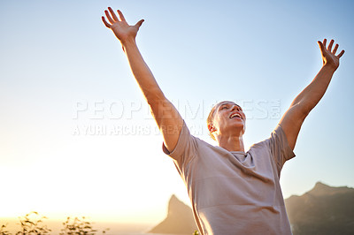 Man standing on the beach with arms outstretched, symbolizing freedom and release from fitness myths.
