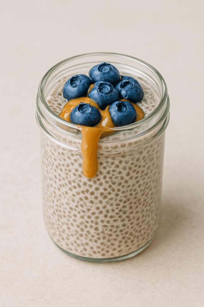 High-protein chia pudding with almond milk and fresh berries in a glass jar