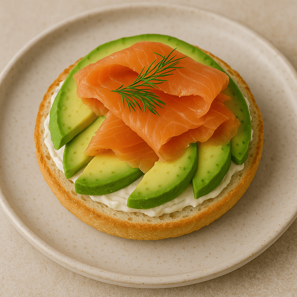 Protein bagel topped with smoked salmon, avocado, and fresh dill